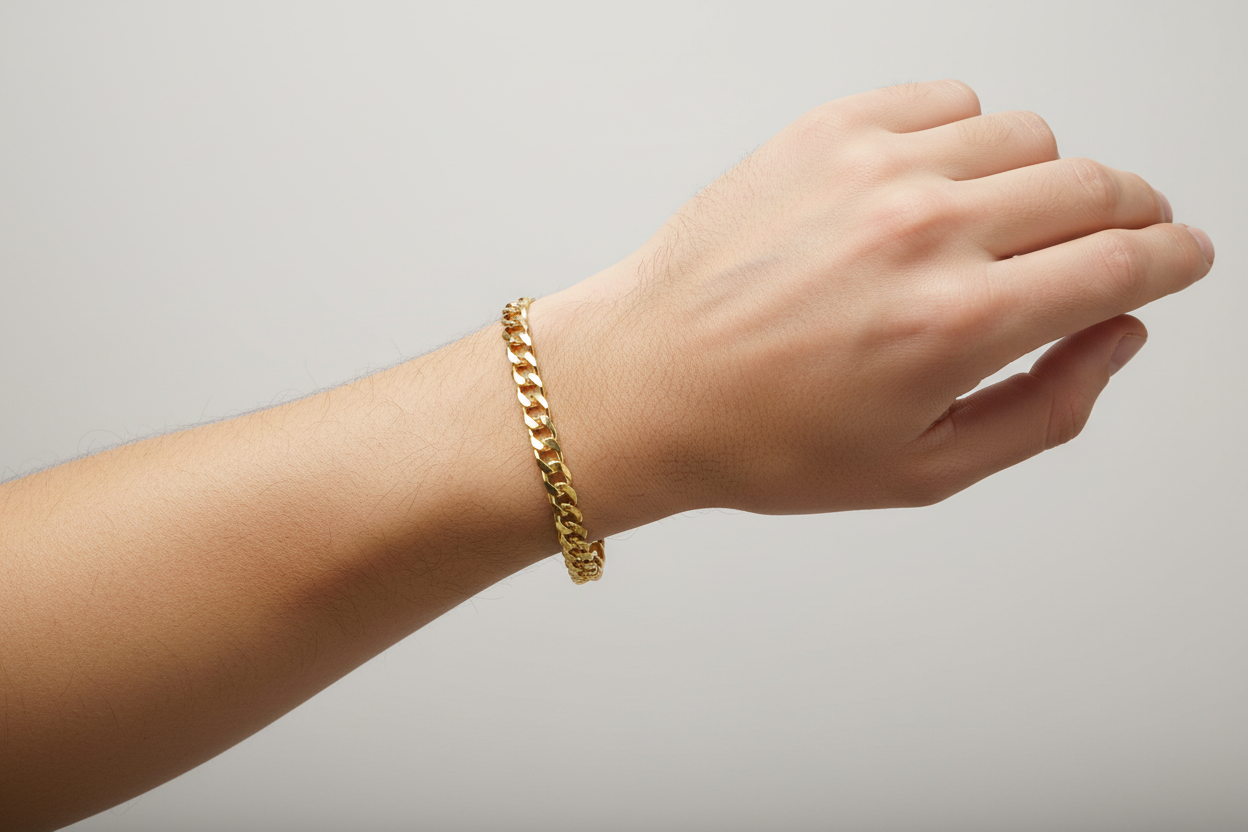 Model wearing 5MM Cuban link bracelet crafted in 14K yellow gold