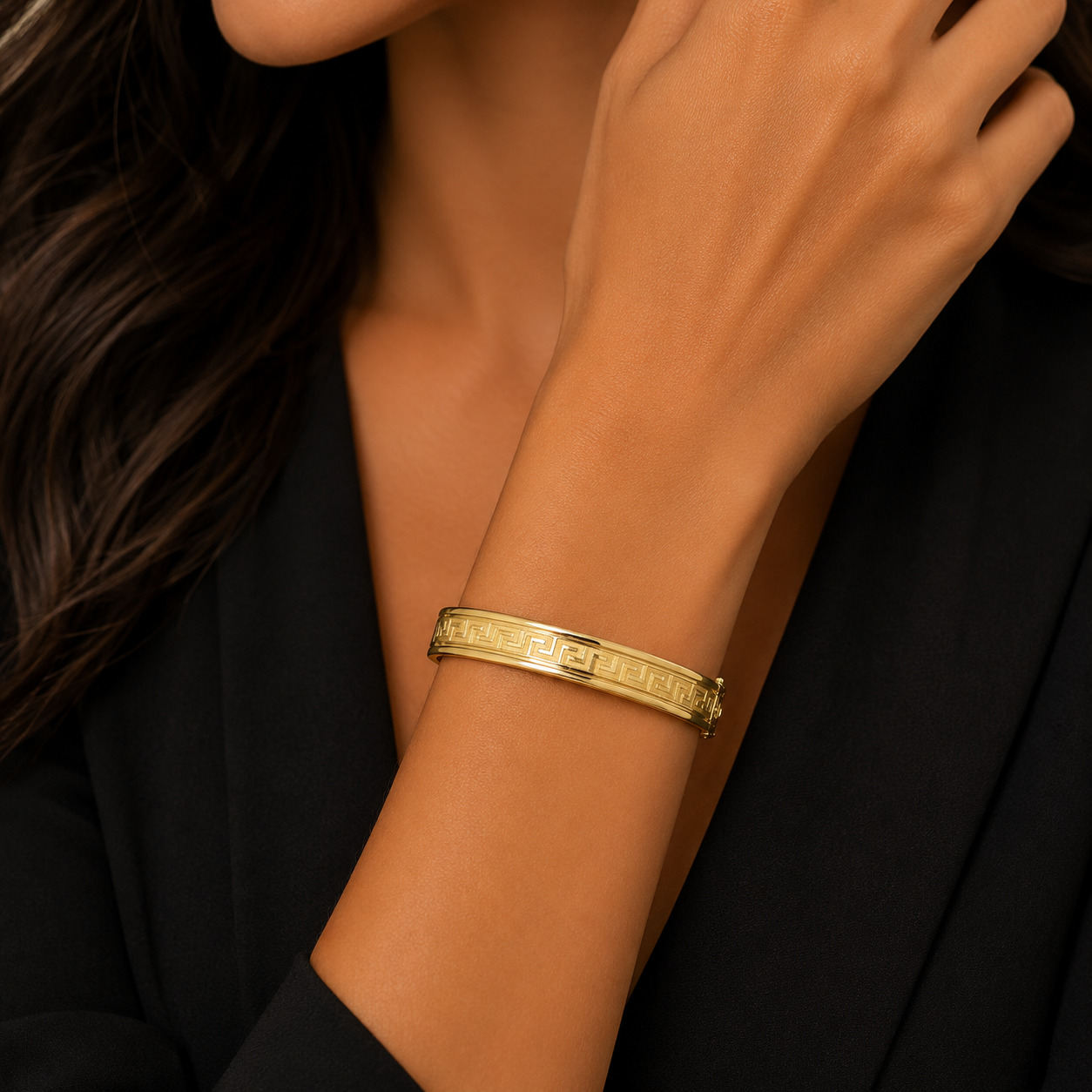 Model wearing 14K gold greek key pattern bangle