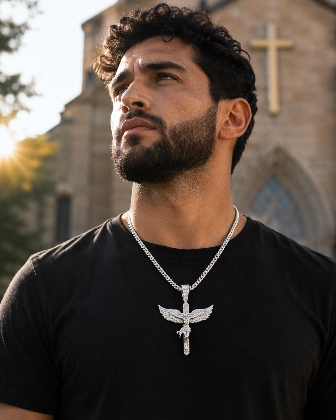 Statement crucifix pendant with angel wing detailing and moissanite stones.