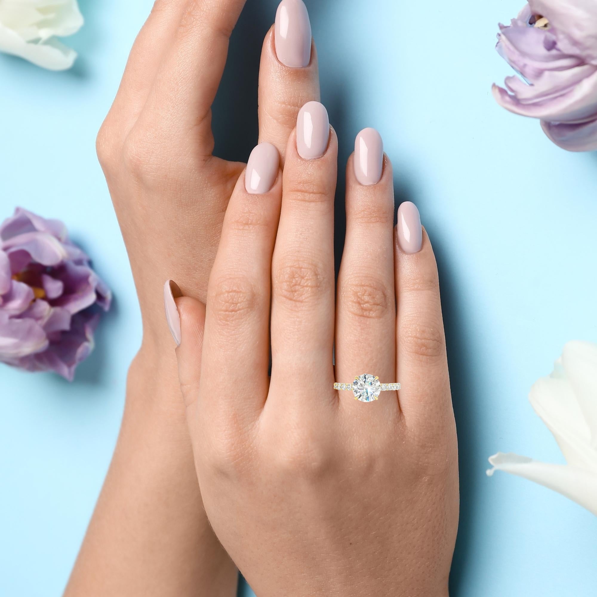 Model wearing round brilliant diamond engagement ring with hidden halo
