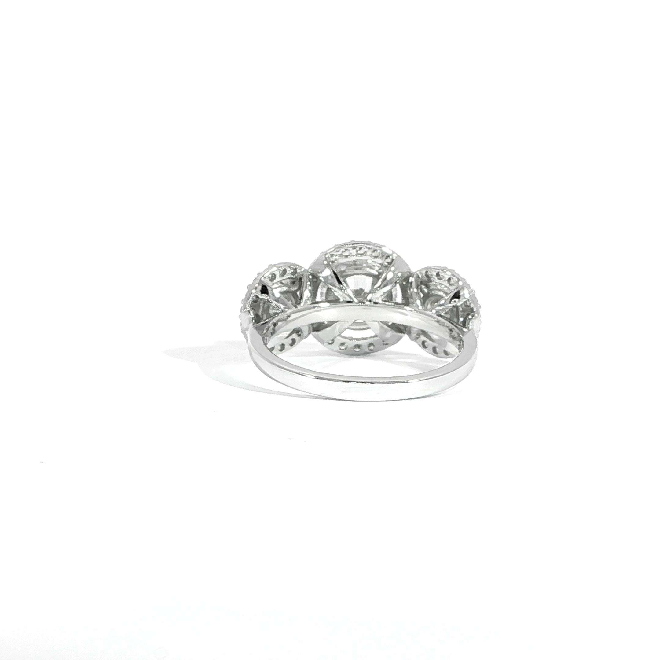 Back view of round three stone diamond ring with halos