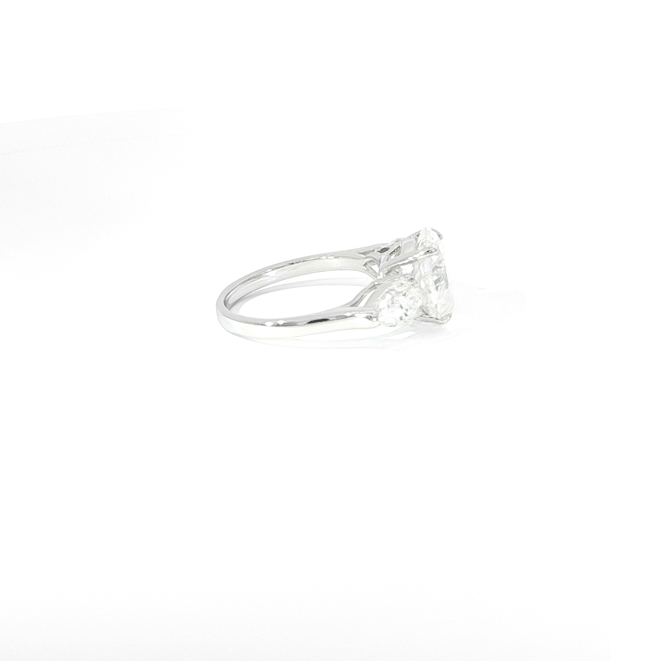 Oval moissanite engagement ring with pear side stones and sterling silver band