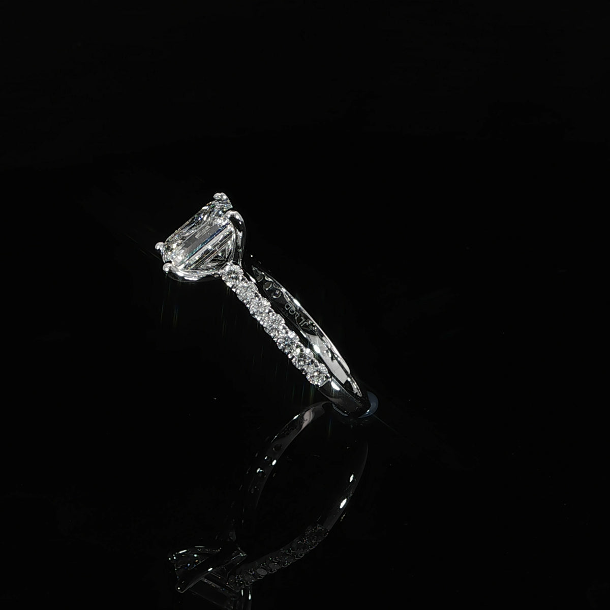 Emerald cut lab grown diamond engagement ring with a pavé diamond band in polished 14K white gold.
