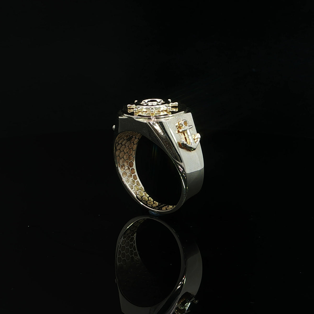 Side profile of a 14K yellow gold mariner ring showing an anchor motif and honeycomb-patterned interior.