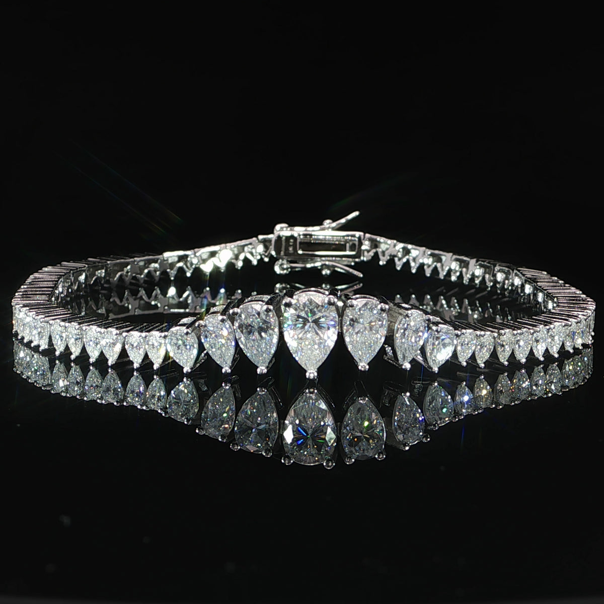 Sterling silver graduated moissanite bracelet photographed against a black background.