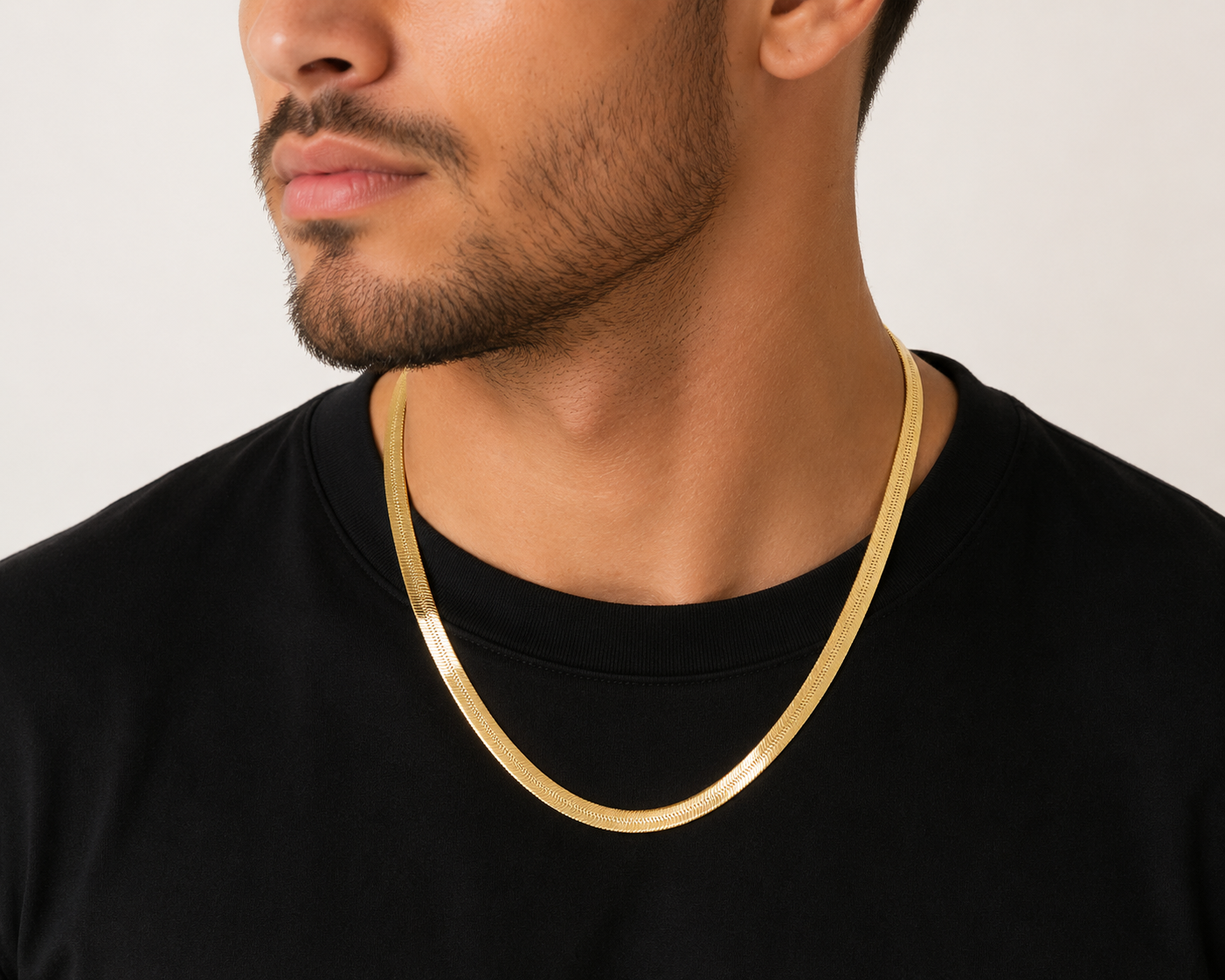 Model Wearing Wide 7MM Herringbone Chain Necklace In Solid 10K Yellow Gold.