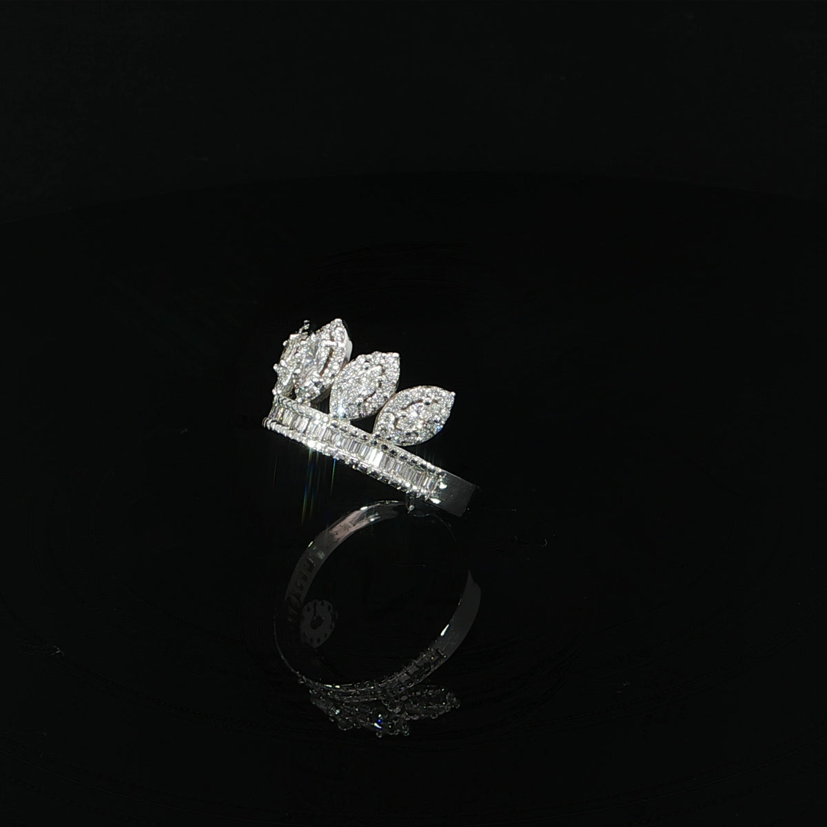 Side angle showing the marquise diamond crown, round diamond halos, and baguette-set base.