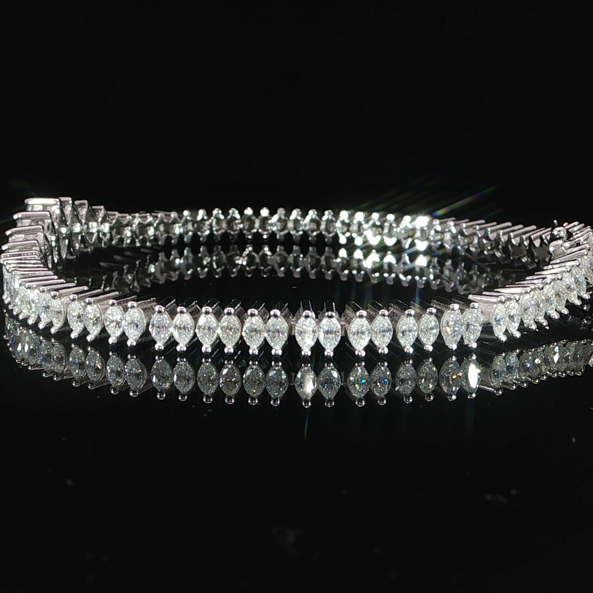 Side view of a marquise-cut moissanite tennis bracelet in sterling silver