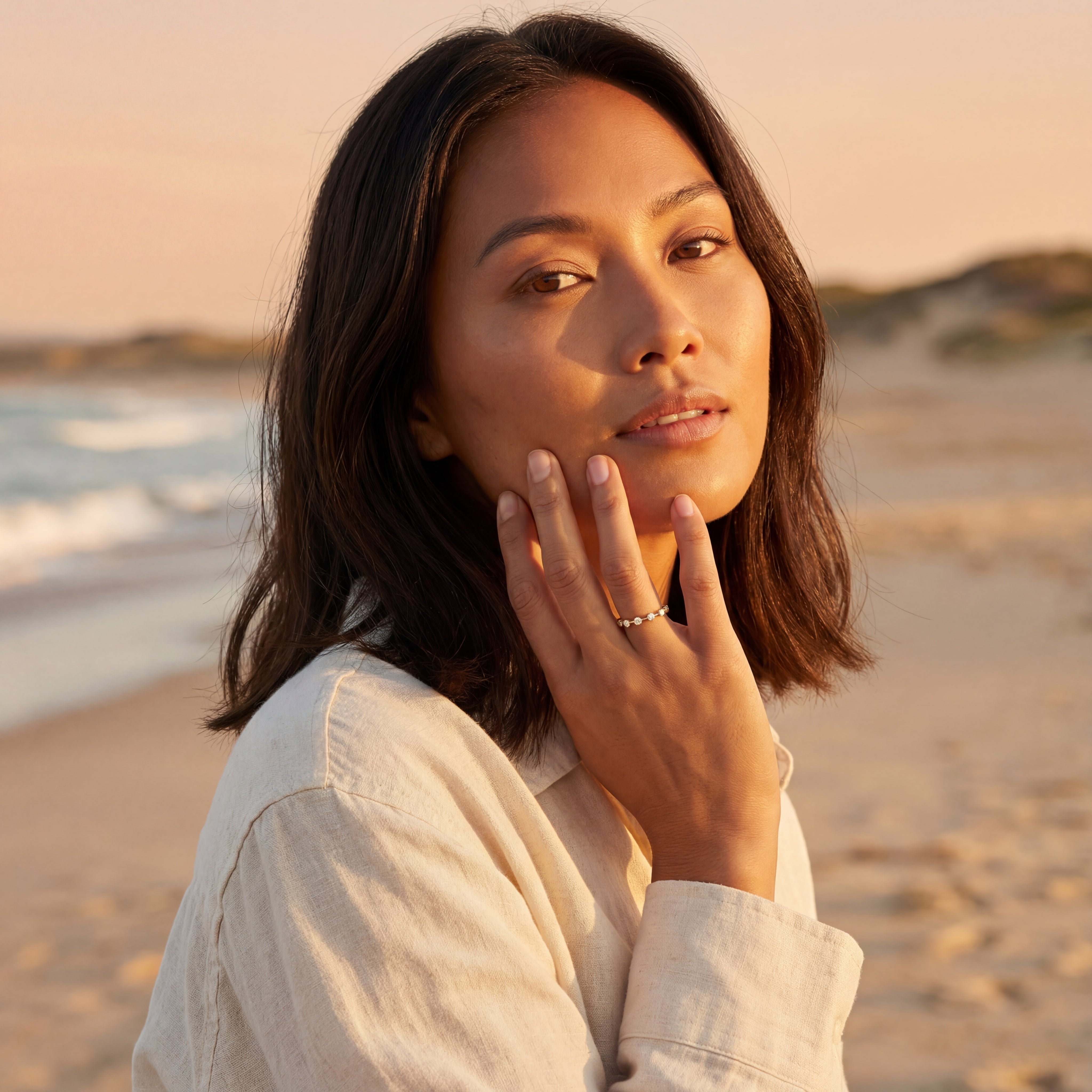 Model wearing stackable minimalist diamond band with bezel set stones
