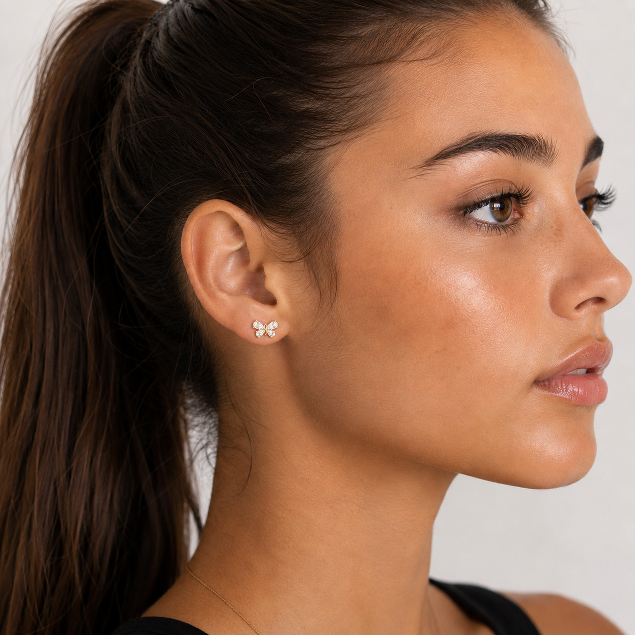 Yellow gold butterfly studs featuring four pear-cut diamond wings