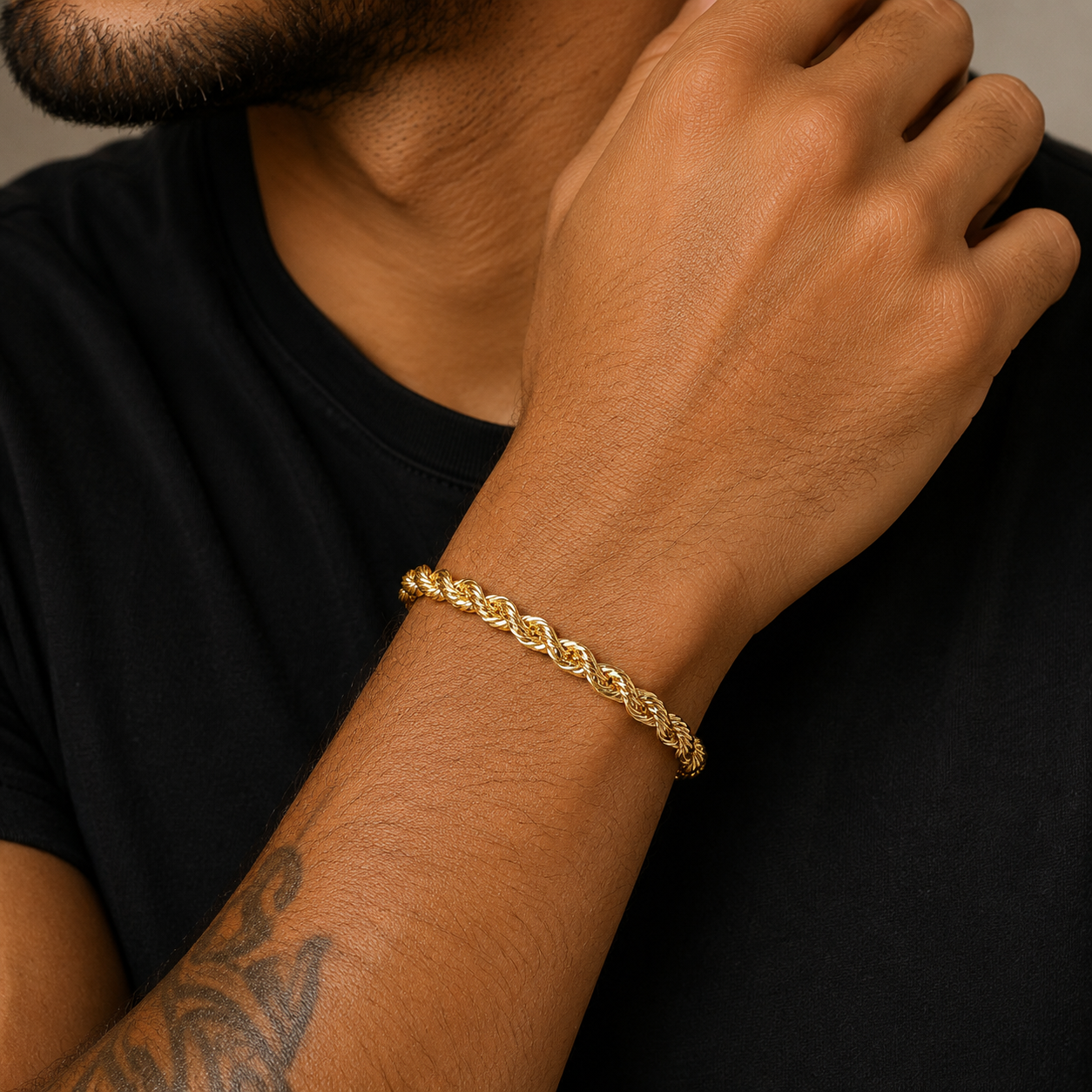 Model wearing 10k yellow gold rope chain bracelet