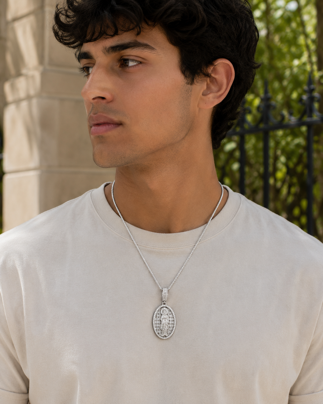 Model wearing hip hop style Virgin Mary oval pendant with baguette stones