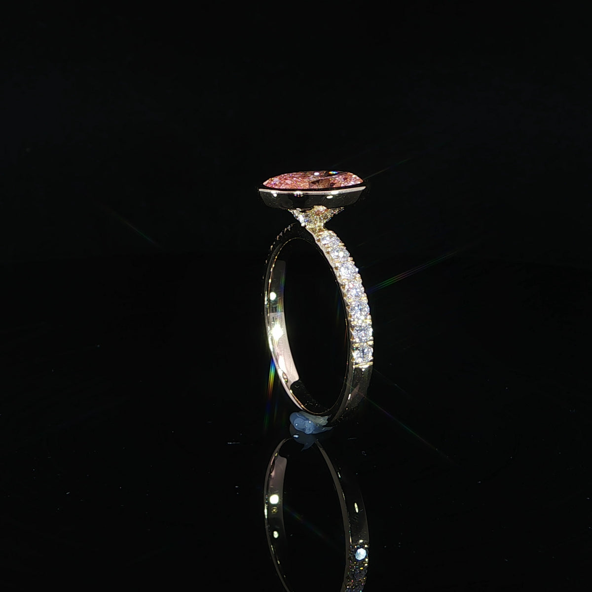 Side detail showing the pink diamond’s raised bezel above the band.