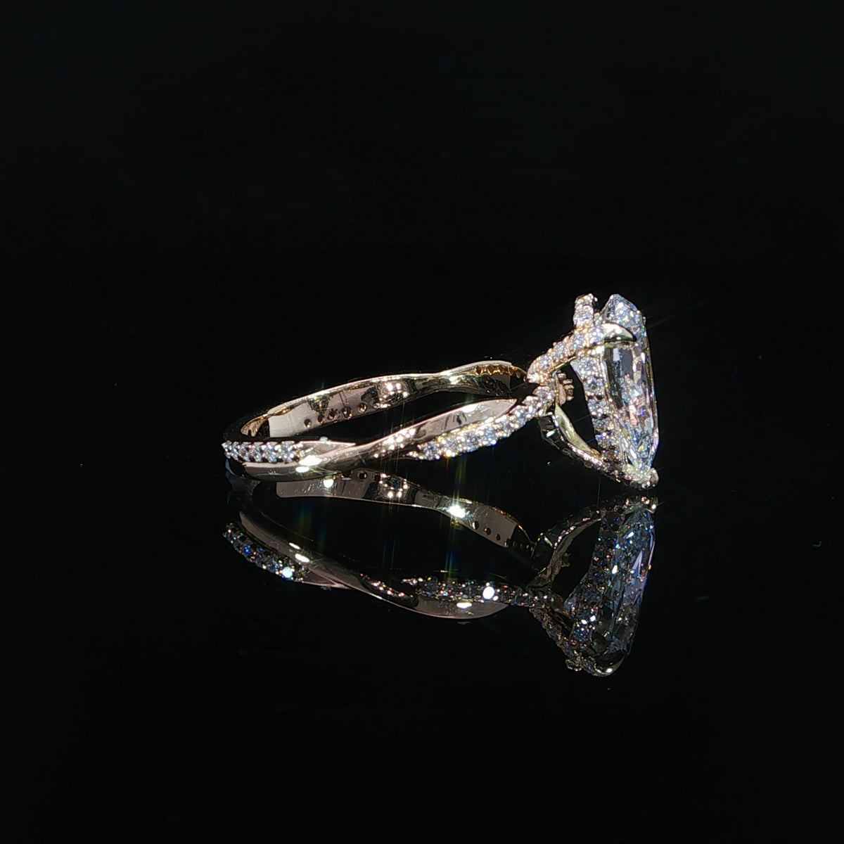 Side profile showing the pear center stone and hidden diamond halo.