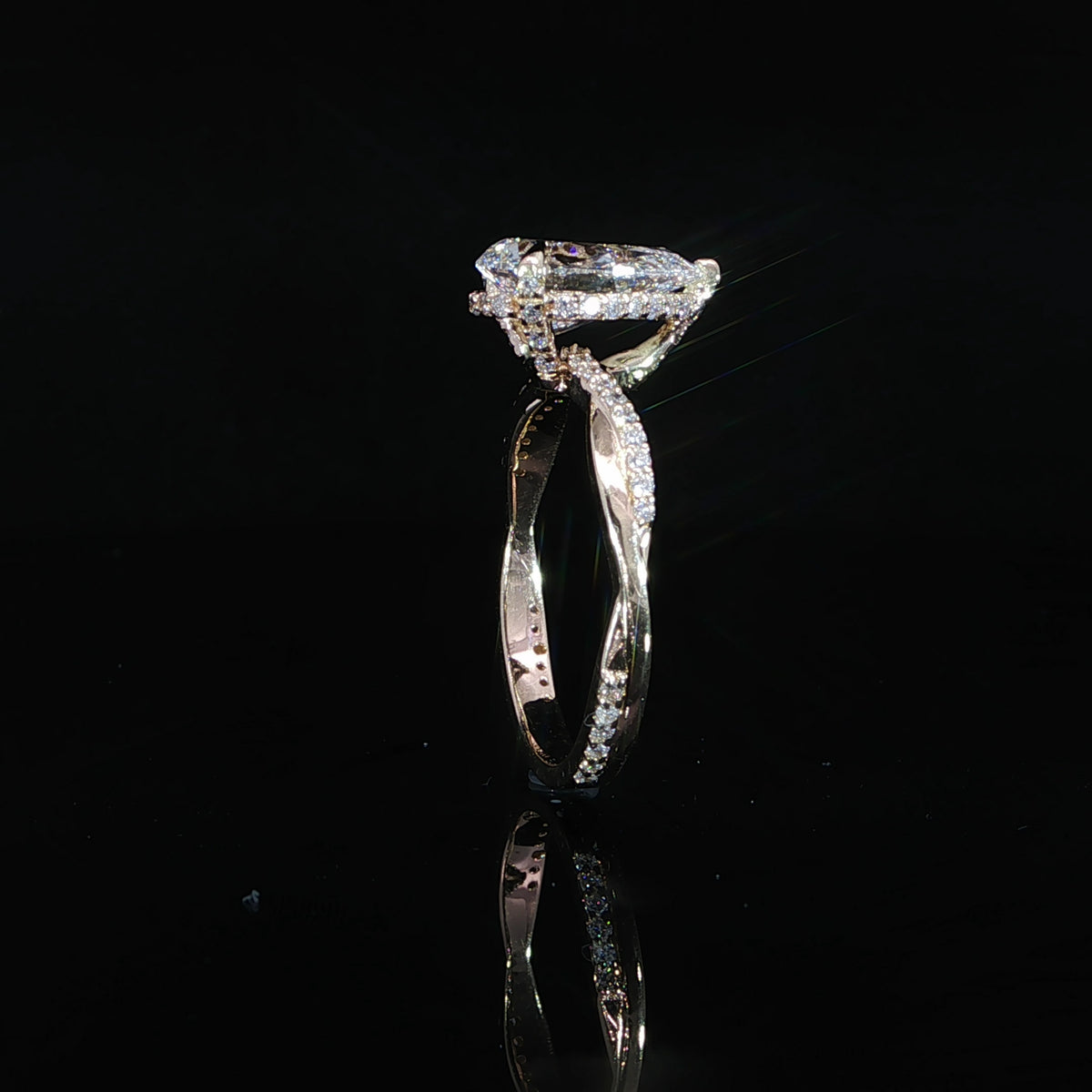 Detailed view of the gallery and prong setting securing the pear diamond.