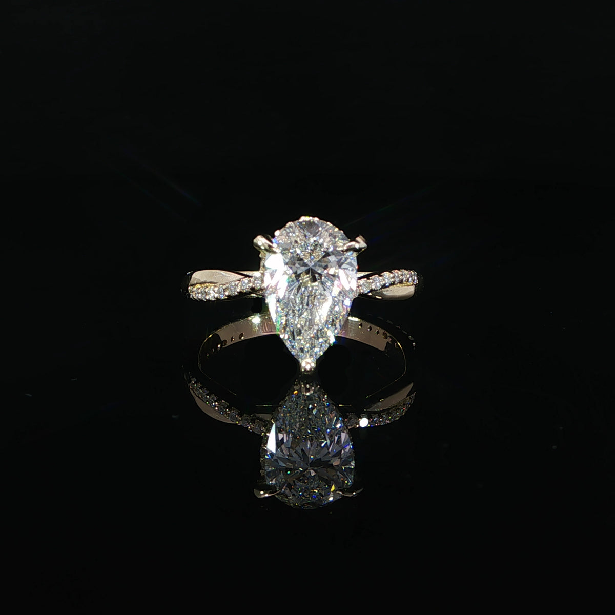 Front view of the 2 CT pear diamond with a delicate twist band.