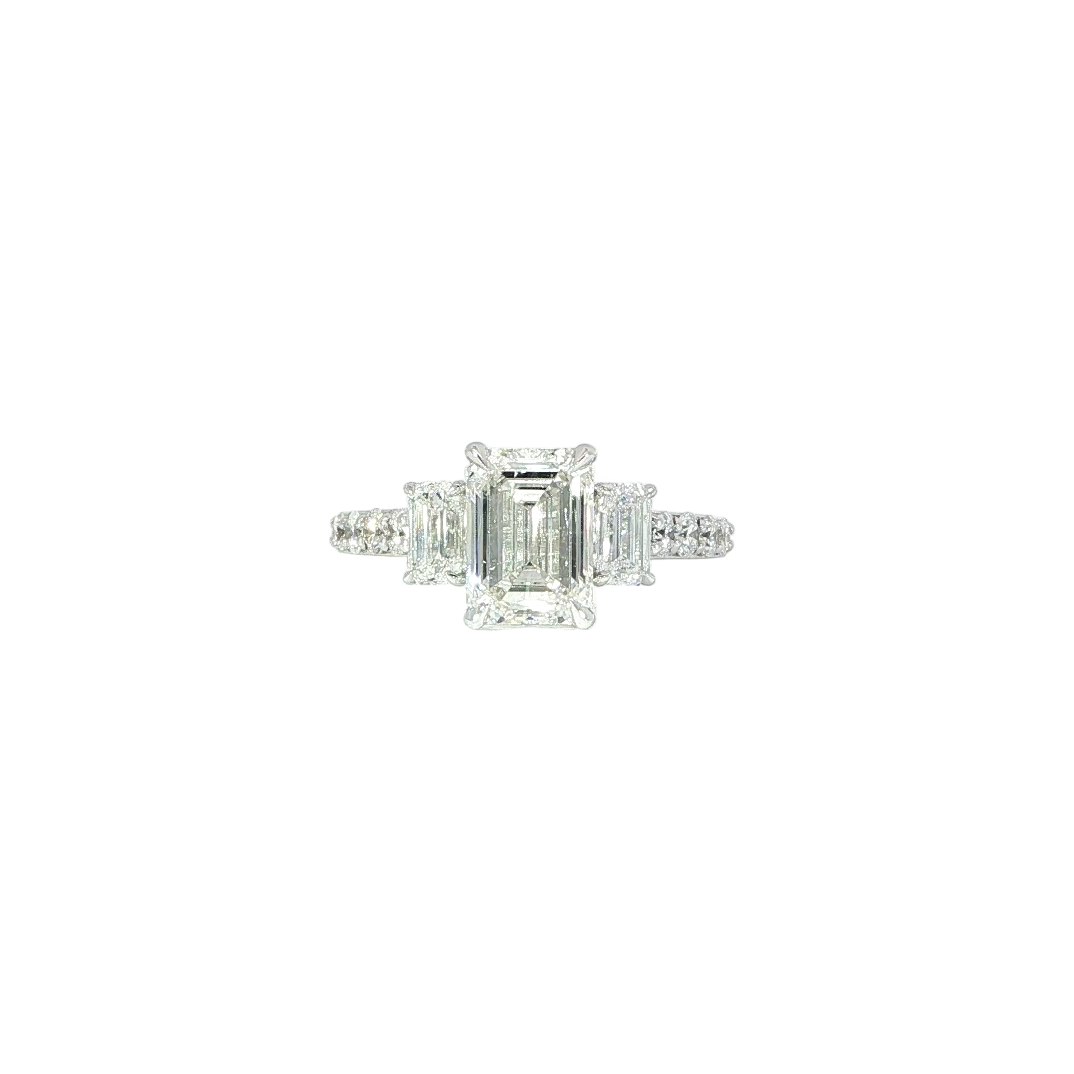 Elegant 3-stone emerald cut engagement ring with pave diamonds