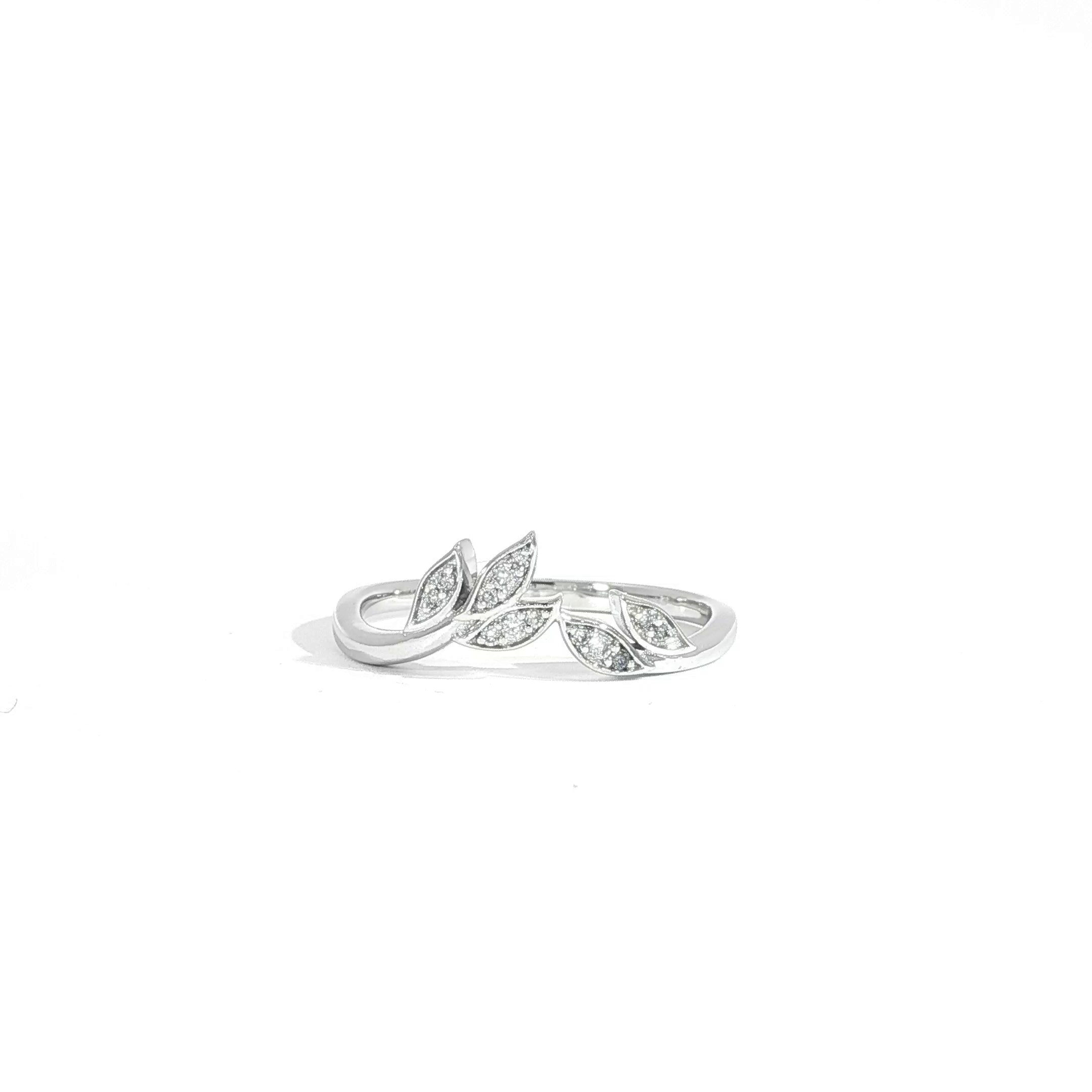 Close up video of curved, stackable diamond leaf ring in 14K gold