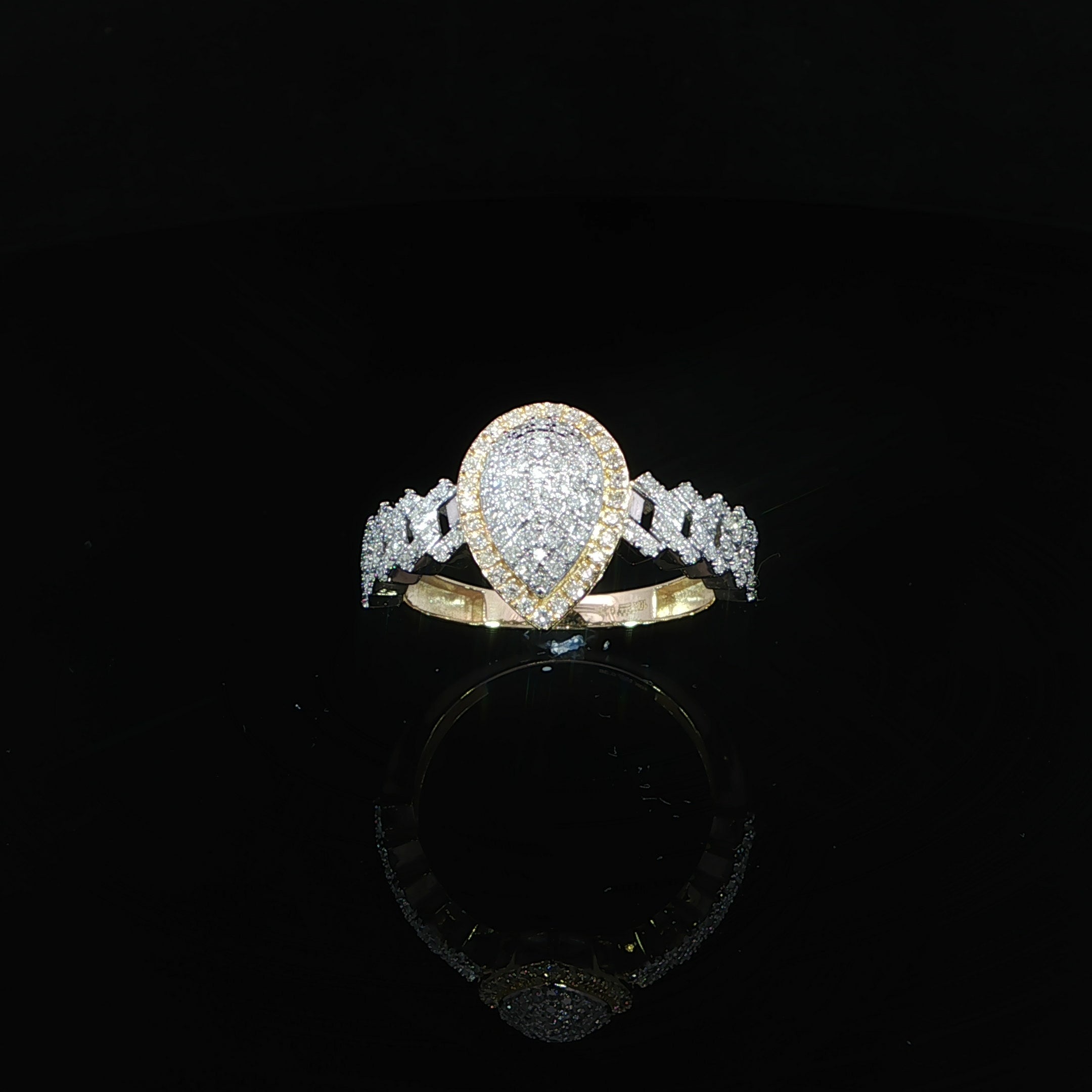 Natural diamond pear halo ring featuring an infinity-style diamond shank