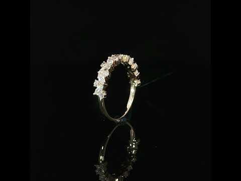 Side view revealing openings beneath the diamond settings of a yellow gold multi-shape band.