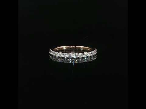 Rose gold band featuring 0.55 CTW of lab-grown diamonds on a reflective black surface.