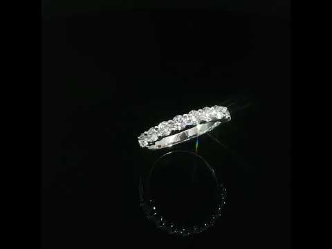 Tilted view of a 1.03 CTW lab-grown diamond band with round diamonds across the upper half.