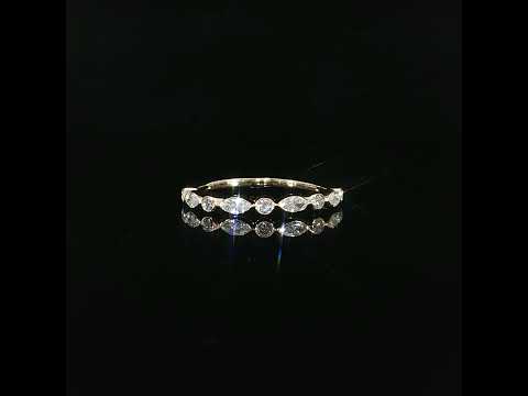 Delicate 14K yellow gold stacking ring featuring 0.41 CTW lab grown diamonds in alternating marquise and round bezel settings.