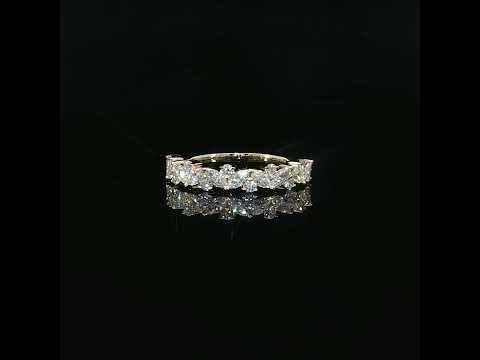 Staggered marquise and round diamonds create an uneven decorative outline across a 14K yellow gold band.