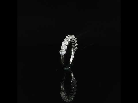 Upright view of an oval diamond half eternity ring showing the setting profile and plain lower band.