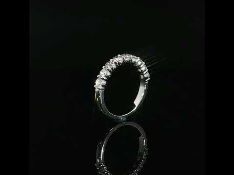 Upright side profile of a half-eternity diamond band showing individual settings and a polished lower shank.