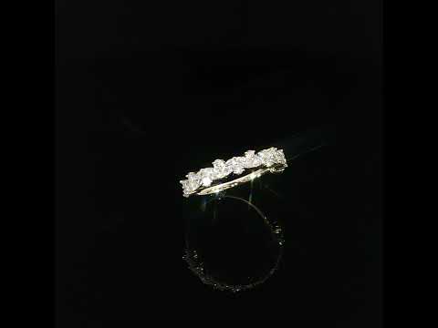 Tilted view of a lab-grown diamond ring with mixed stone shapes held by yellow gold prongs.