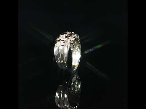 Side detail of a 14K yellow gold nugget ring showing its smooth polished tapered shank and contrasting irregular diamond-cut top.