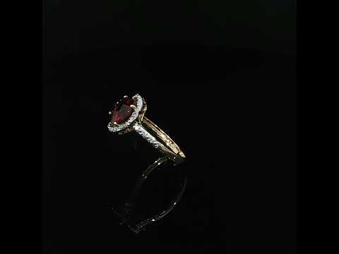 Natural red garnet ring in 14K yellow gold with a diamond halo and accented band, totaling 0.10 CTW.