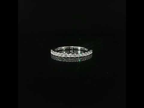 A continuous row of round diamonds spans the top of a polished 14K white gold ring.