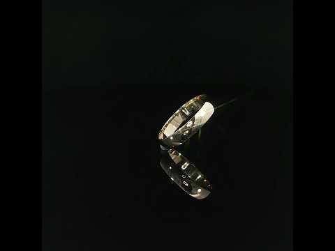 Angled view of a 14K solid gold 4mm wedding band highlighting its uninterrupted polished exterior and softly rounded edges.
