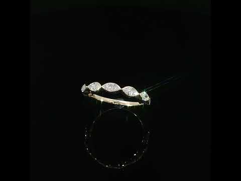 Tilted view of a 14K yellow gold ring with lab-grown marquise diamonds and a polished inner shank.