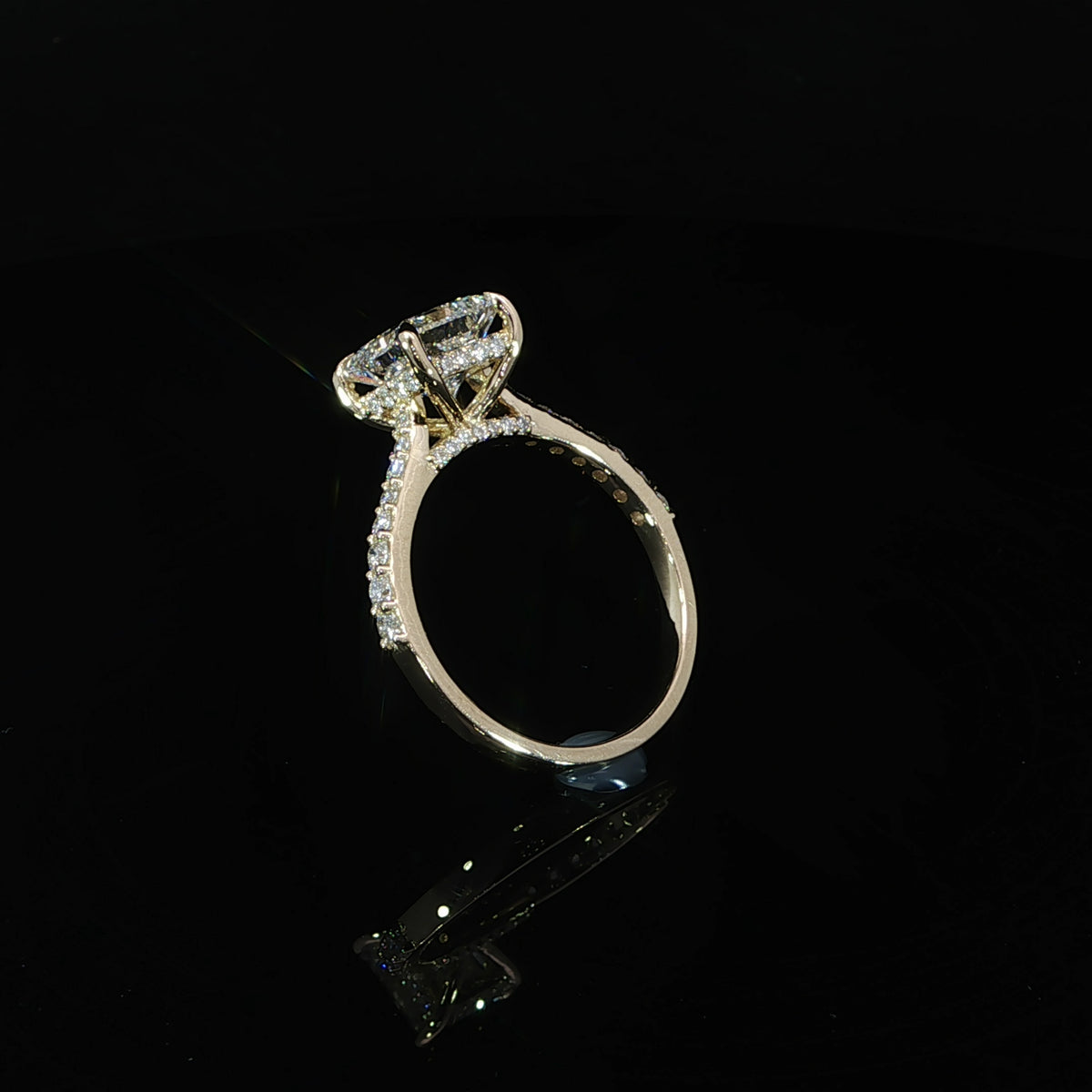 Side profile of a princess cut diamond engagement ring showing the raised cathedral setting and diamond accents.