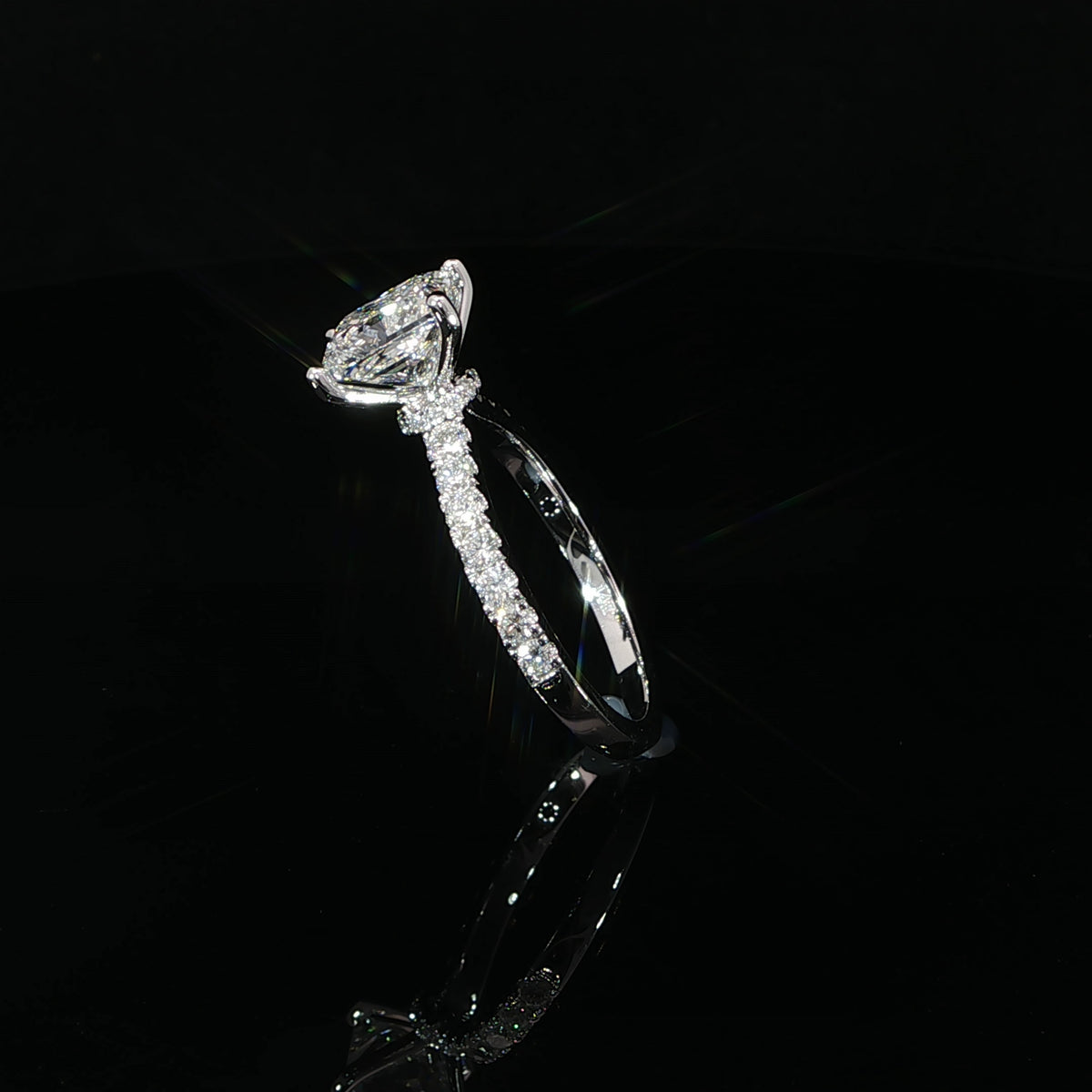 Side profile of princess cut diamond engagement ring showing the hidden halo beneath the center stone.