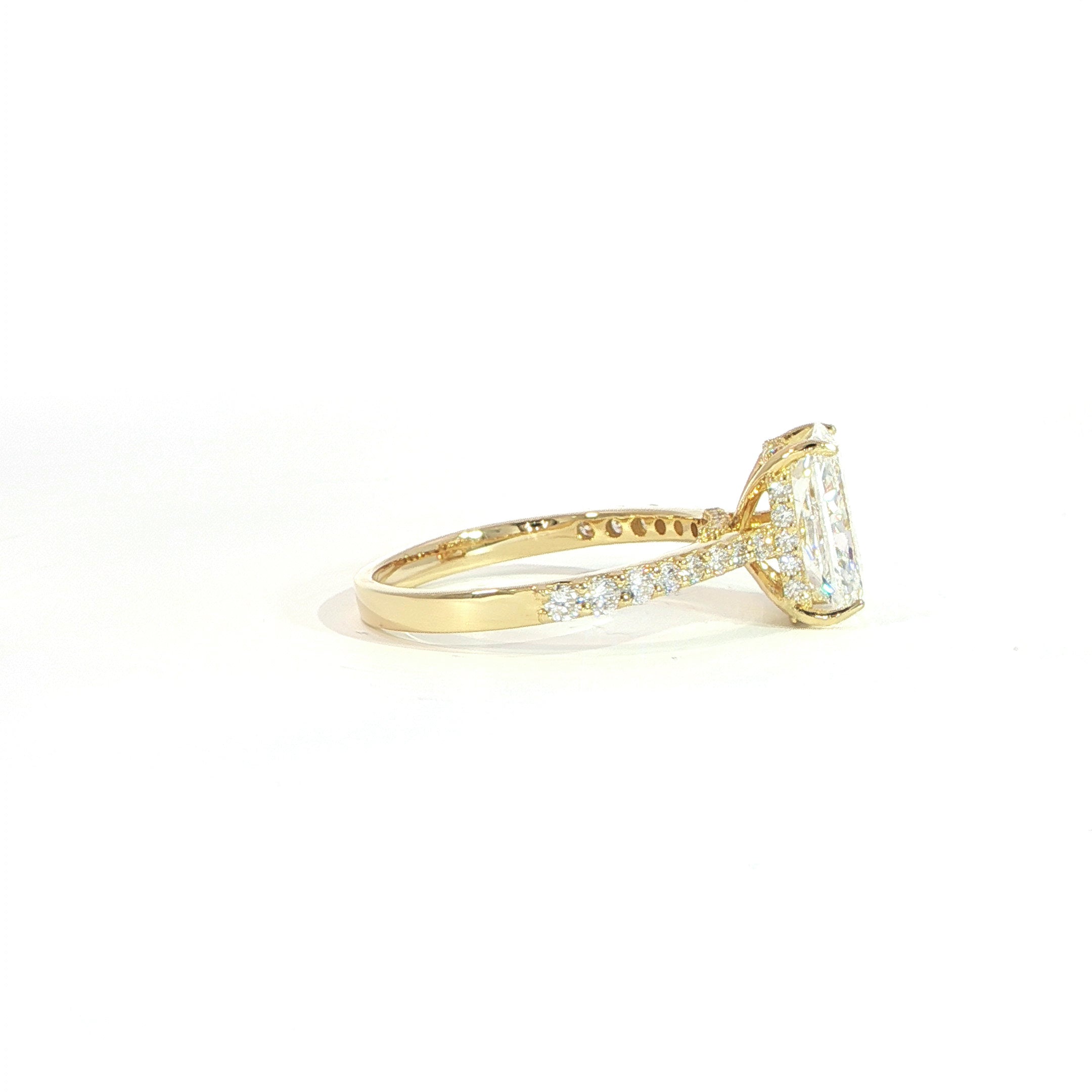 Side view of radiant diamond engagement ring with hidden halo