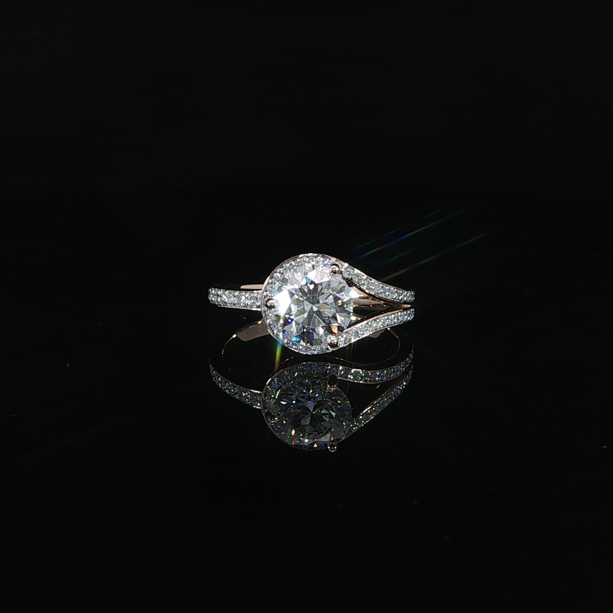 Rose gold engagement ring with a round center diamond framed by a unique swirling bypass band.