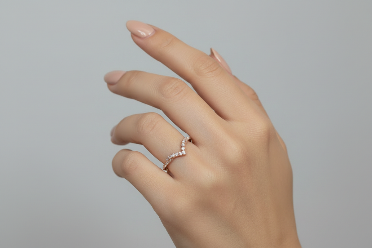 Hand model showing off a 14k rose gold diamond band