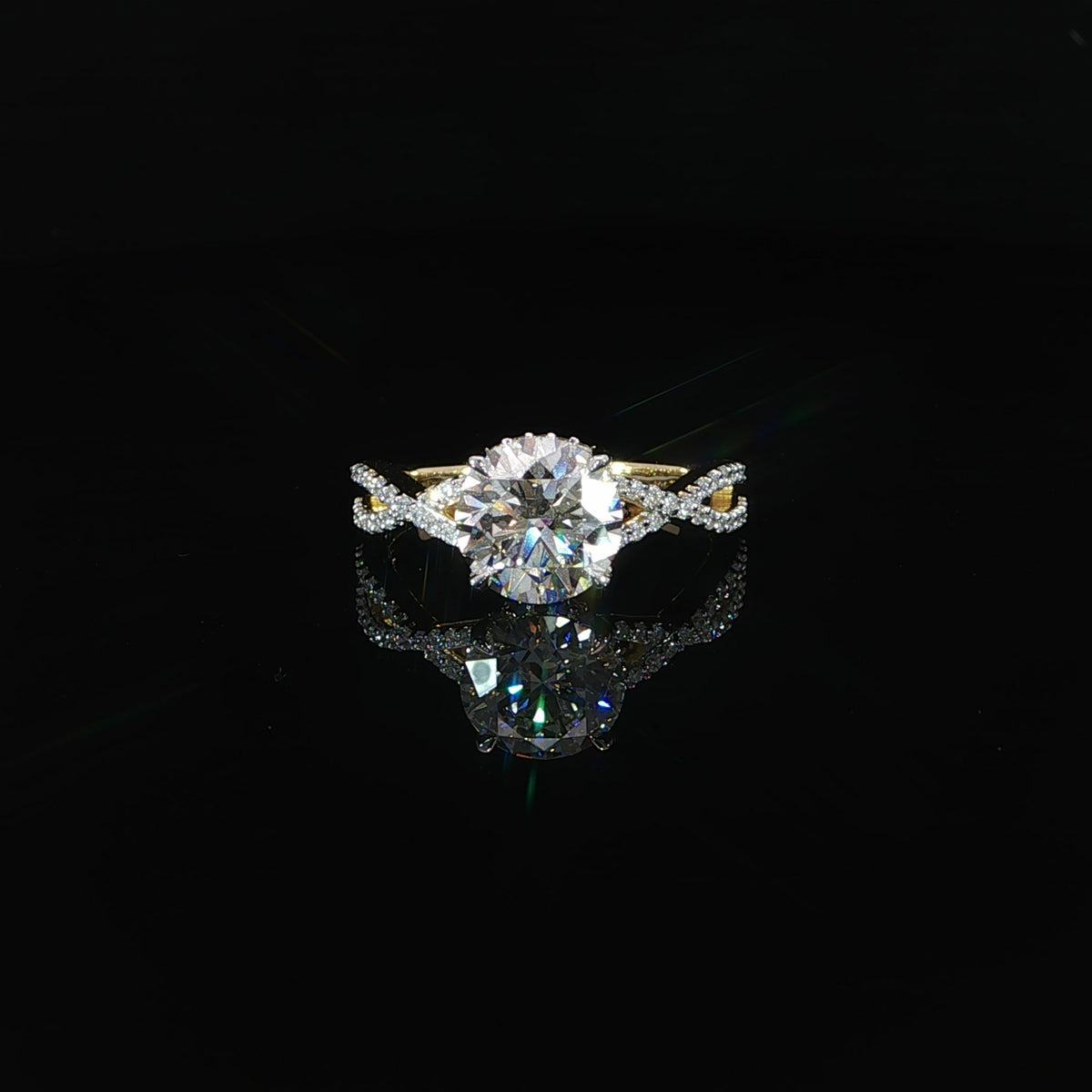 Front view of a round diamond engagement ring featuring a hidden halo and sparkling twist band.