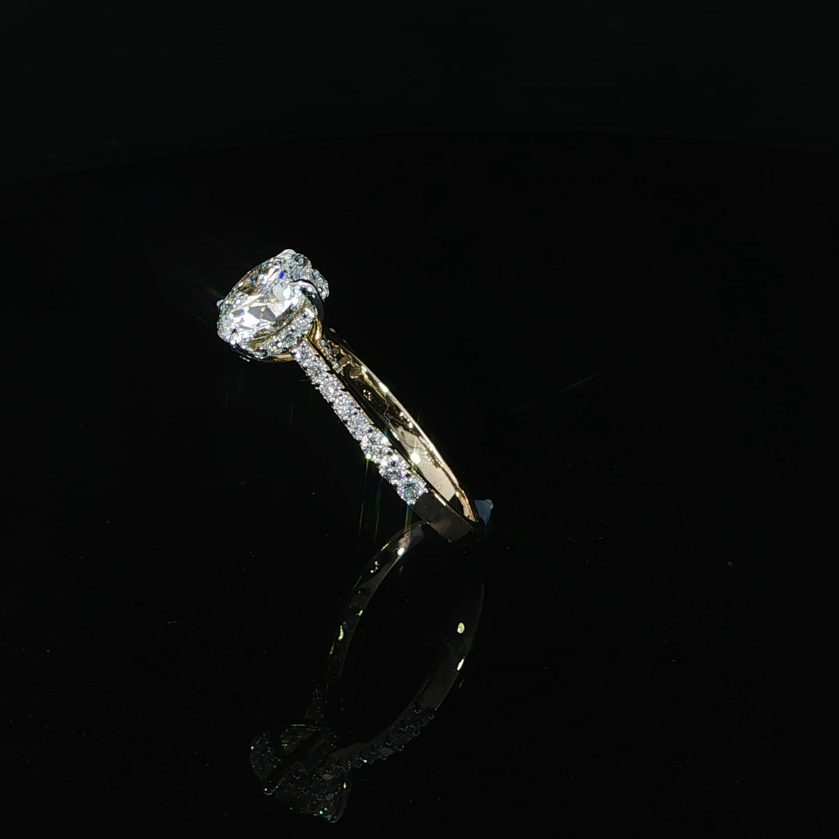 Side profile showing the cathedral setting and hidden halo beneath the round lab-grown center diamond.