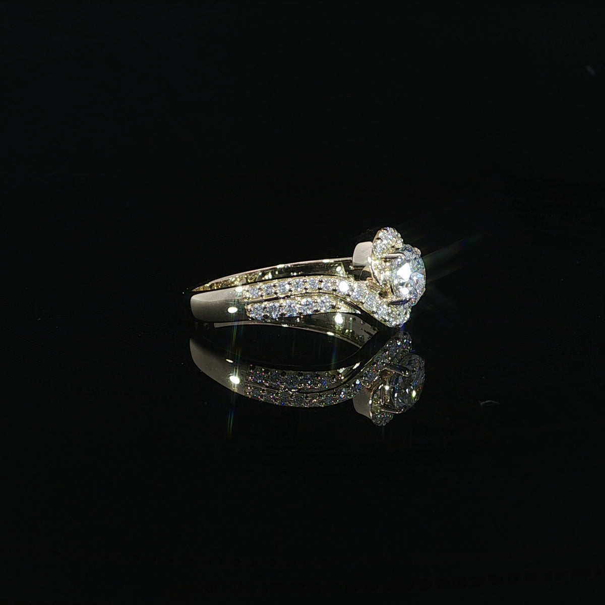 Round lab grown diamond engagement ring with a flowing bypass setting and pavé diamond band.