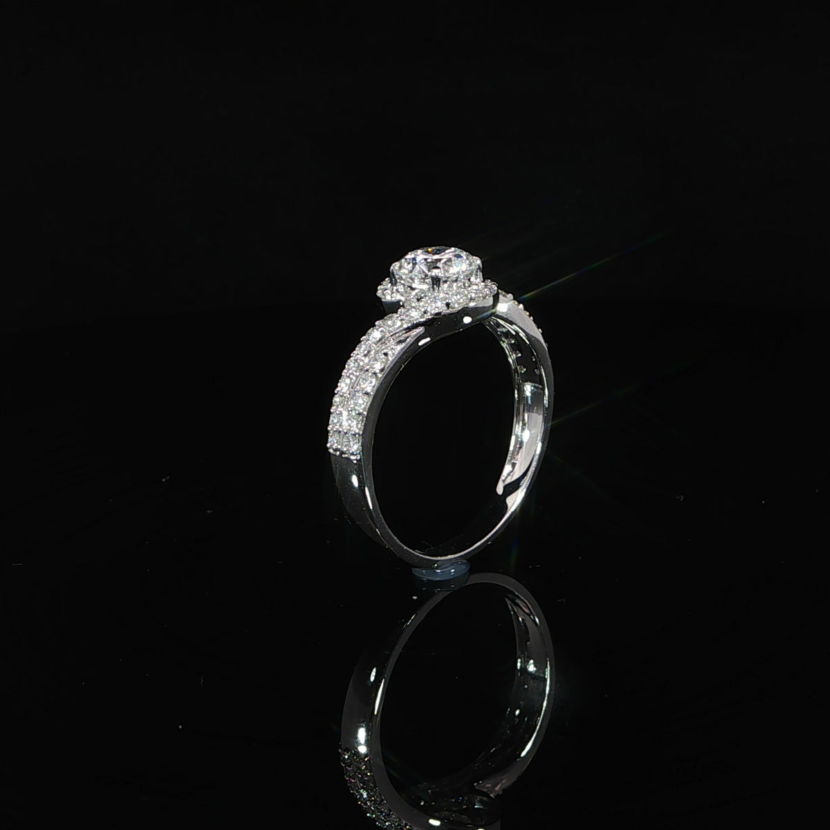 Round lab grown diamond engagement ring with a flowing bypass design and pavé diamond band in white gold.