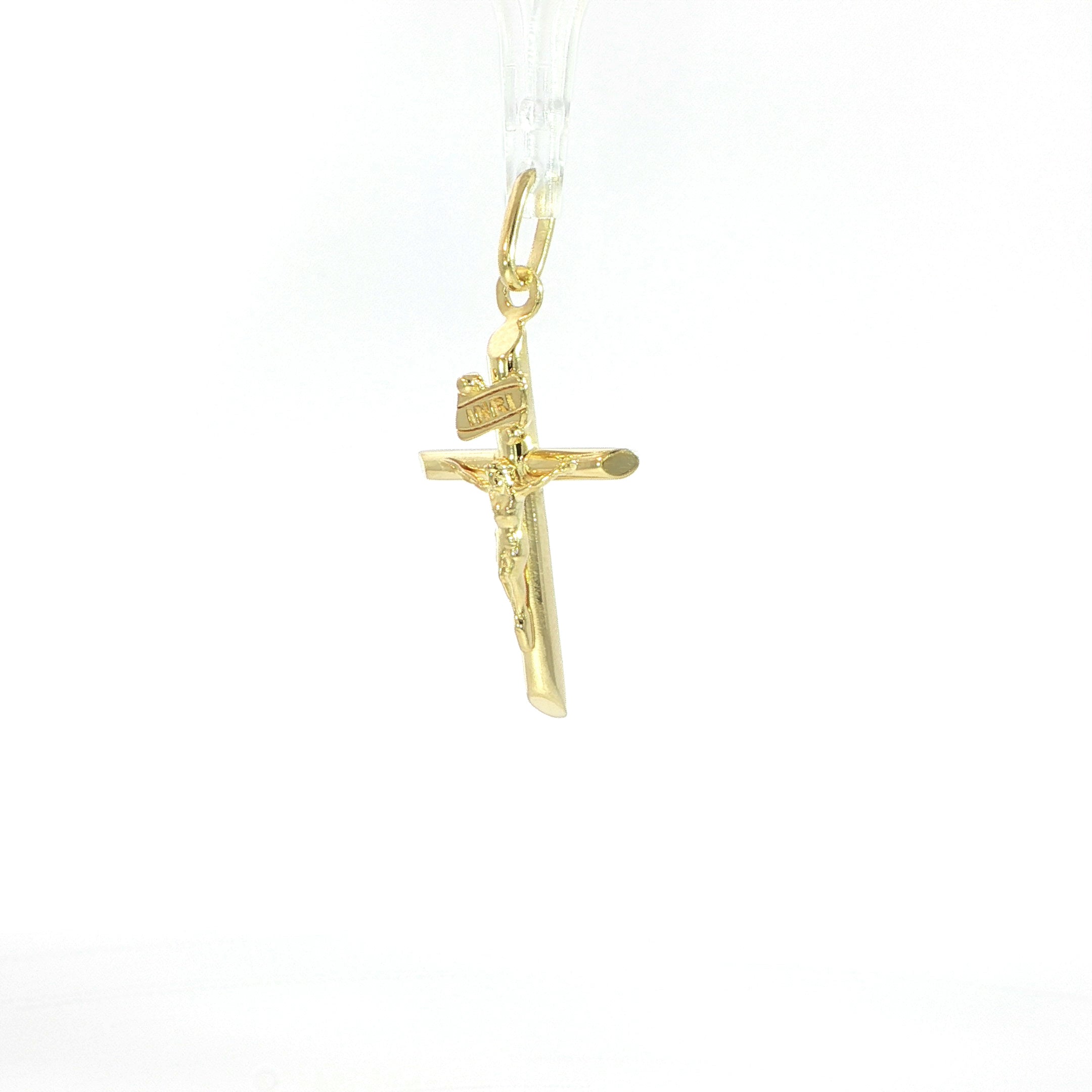Religious cross pendant with detailed figure of Christ.