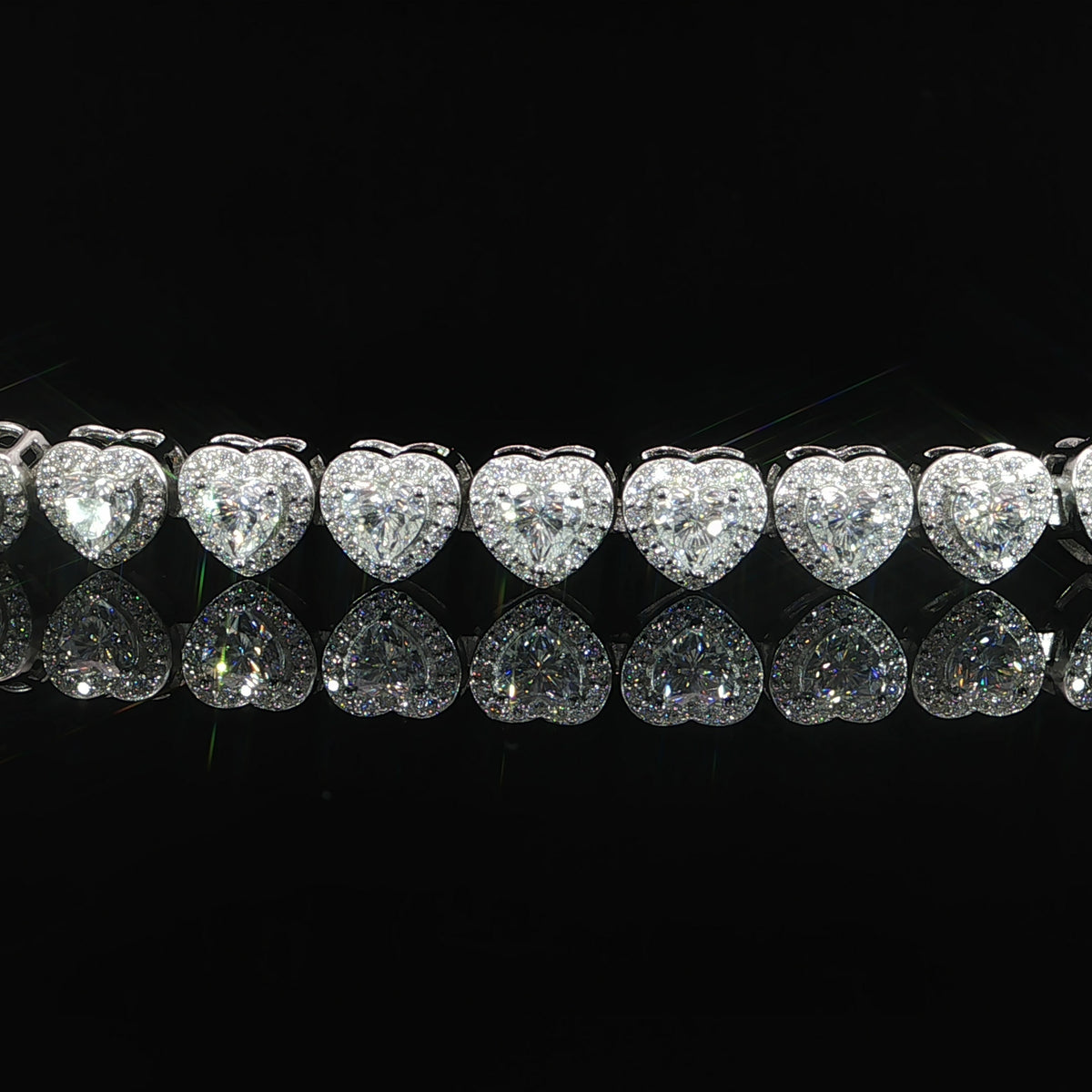Close-up of heart-cut VVS moissanite surrounded by sparkling halos