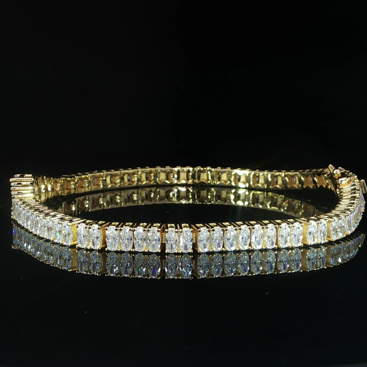 Side view of a sterling silver oval-cut moissanite tennis bracelet