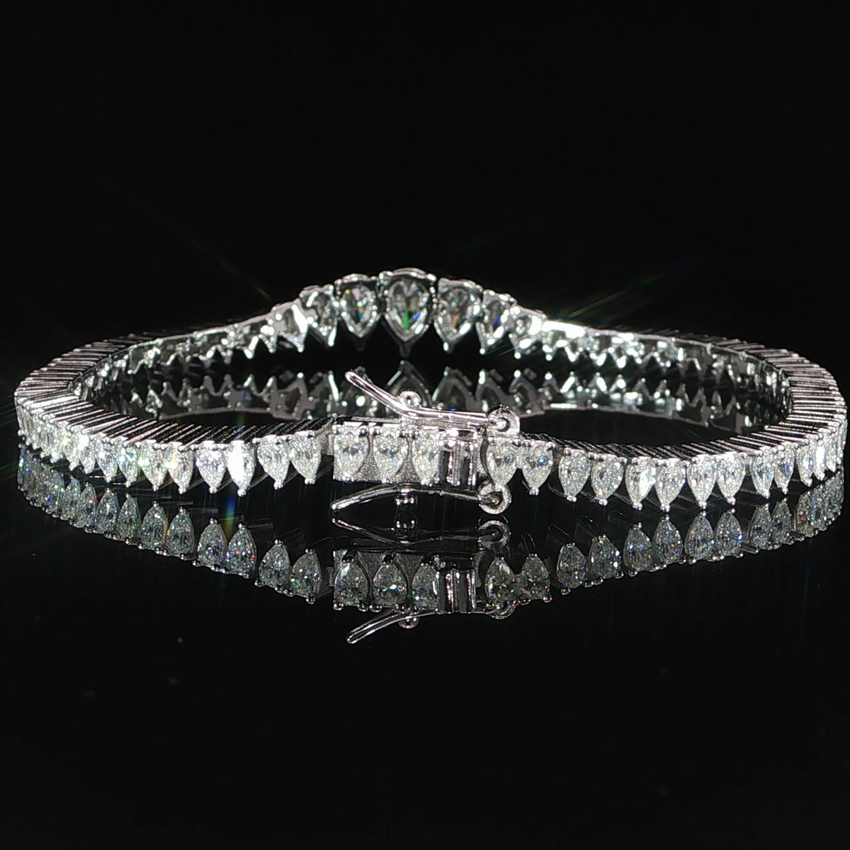 Detailed view of the sterling silver tennis bracelet clasp and safety closure.