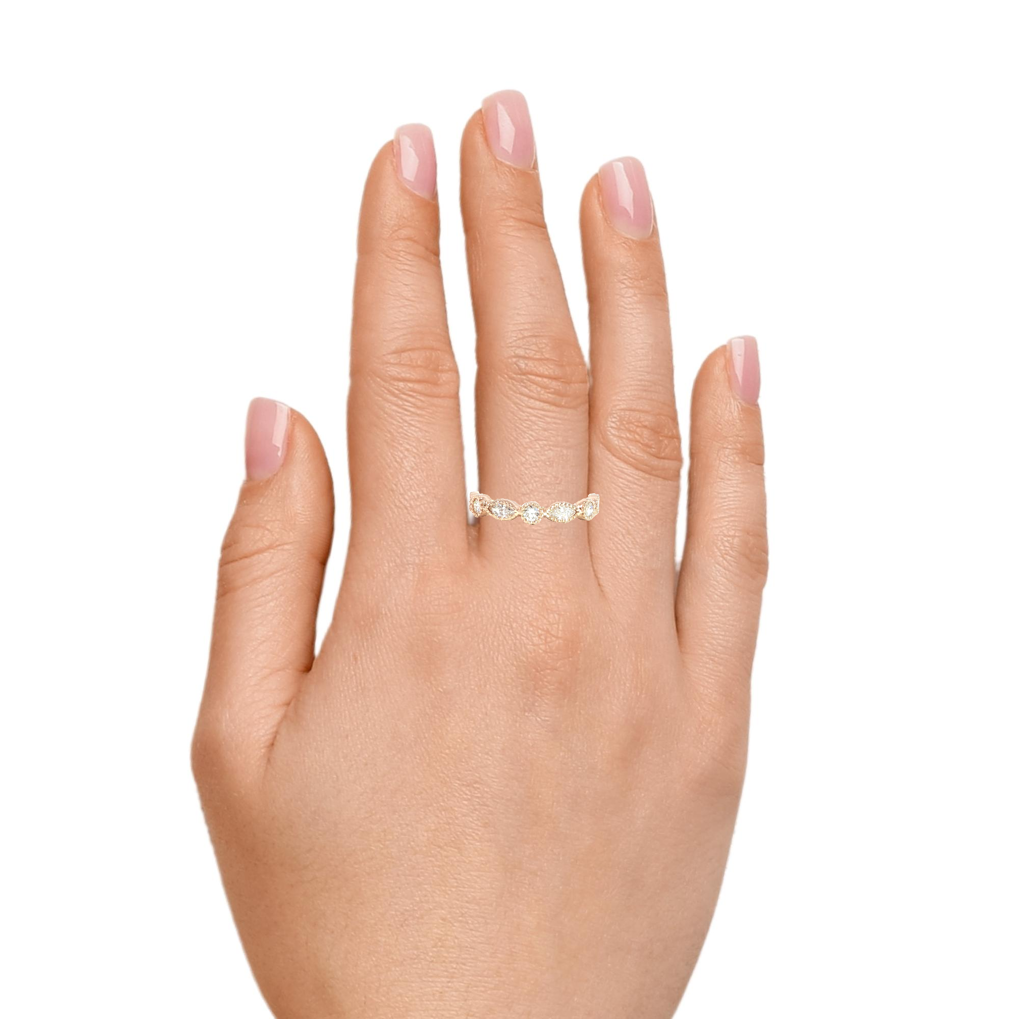 Model wearing stackable vintage diamond ring with milgrain edges
